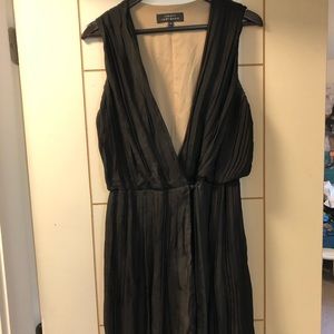 Black pleated, deep plunge dress.